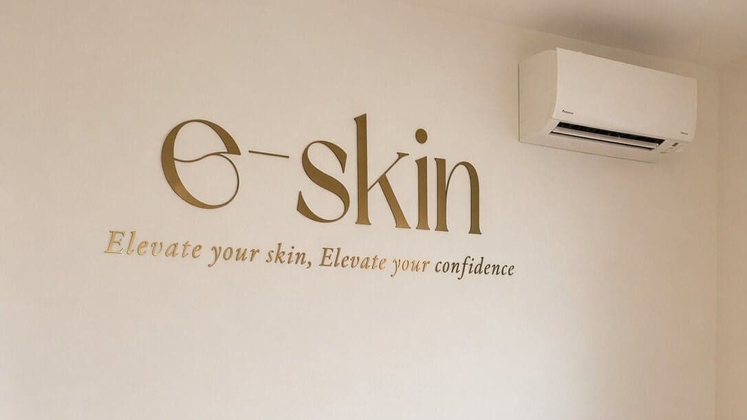 Gold e-skin lettering on the clinic wall reading Elevate your skin, Elevate your confidence